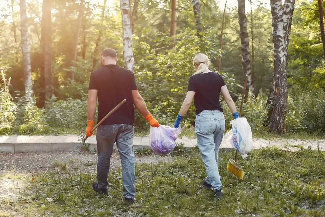 Volunteers collecting litter in a park.