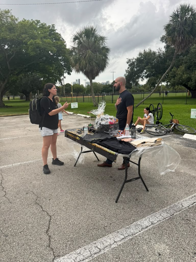 Associate Attorney Harry Kaklamanakis speaking with a community member at the Fort Lauderdale Community Bike Welcome event